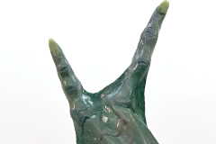 animatronic alien hand with three fingers showing realistic slimy silicone skin and support rod and electrical servo wire cable coming out the back