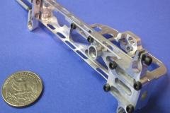 cnc animatronic machining tiny parts showing a quarter next to it to give scale and all hardware
