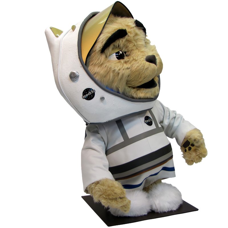 Custom animatronic bulldog mascot in business suit—furry head with grumpy expression, woman interacting at trade show booth