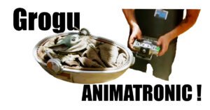 Grogu animatronic puppet in his pram with puppeteer controlling him on The Mandalorian set